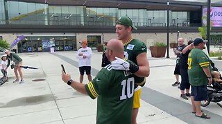 Lukas Van Ness takes pictures with fans before Packers training camp