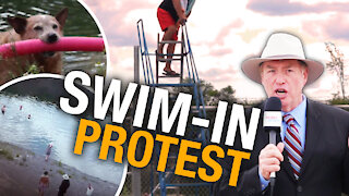 Residents pass barbed wire fence, hold “swim-in” protest to reclaim Harold Quarry