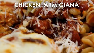 Chicken Parmigiana with pasta and rich, aromatic tomato sauce.