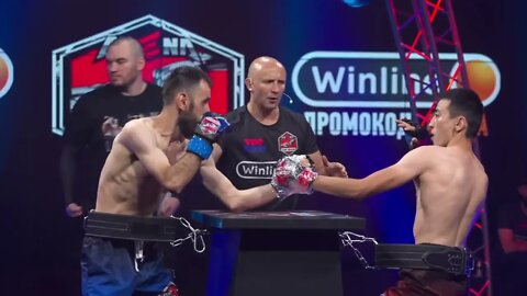 Two Russian Boxers Fight While Strapped To A Table In Bizarre Format Dubbed 'Arm Boxing'