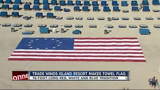 Terry cloth American flag tribute lines beach in front of TradeWinds Island Resorts