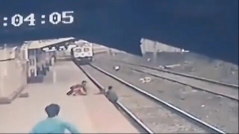 MAN SAVES CHILD'S LIFE FROM ONCOMING TRAIN IN HEART STOPPING VIDEO