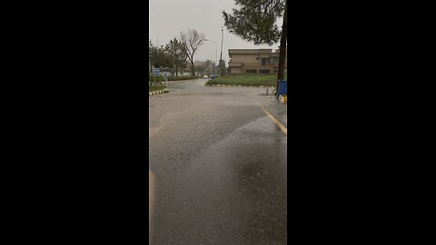 Navigating the Deluge: Walking Through a Street Flooded by a Heavy Rainstorm”