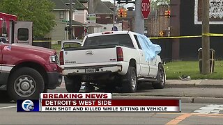 Man shot and killed while sitting in vehicle