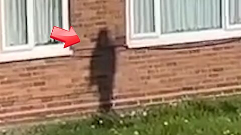 The shadow clinging to the wall of the brick house - is it a ghost or an illusion?