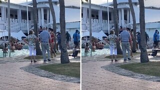 Elderly couple adorably dance together while on vacation