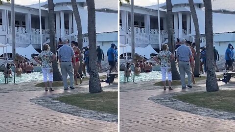 Elderly couple adorably dance together while on vacation