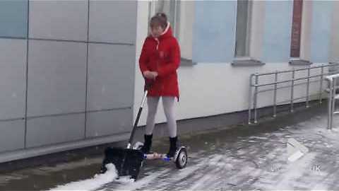 Woman Makes Good Use Of Hoverboard After A Snowy Day