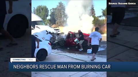 Neighbors rescue man from burning car