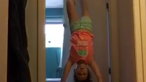 Little Girl Does a Handstand and Falls Through Open Door