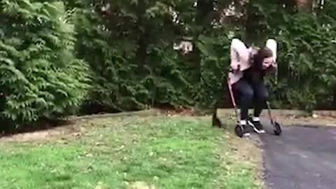 Girl Rolls Down Hill In Wheelchair Into Trees