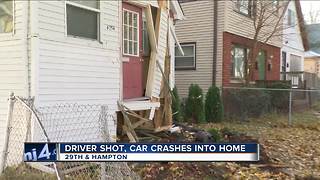 Car crashes into house after driver is shot