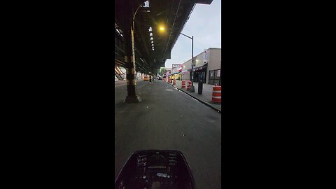 Riding a bicycle in Astoria, Queens on my way to a self service laundromat. May 26, 2024.