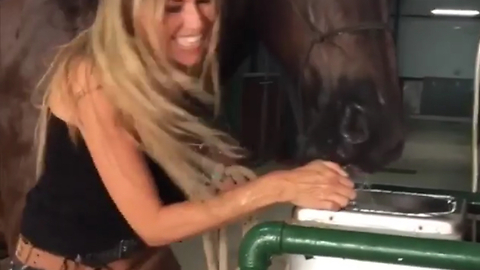 Thirsty Horse And Girl Drink From Water Fountain In Unison