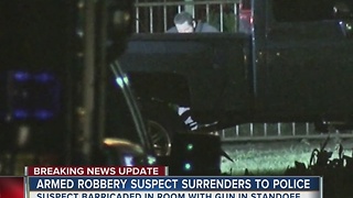 Armed robbery suspect surrenders after all night standoff