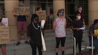 Demonstrators gather in peaceful protest outside Fort Myers Federal Court