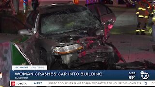 Woman taken to hospital after car crashes into building