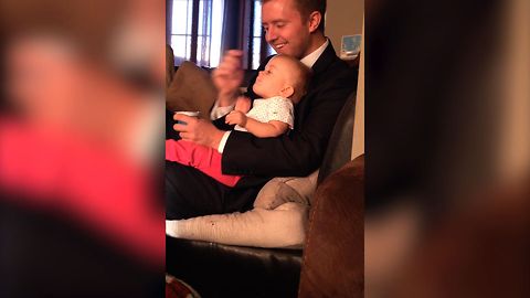 Dad Gets Distracted While Feeding Baby