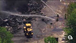 Fire crews work to contain large fire at salvage yard in Carlisle Township