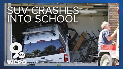 Raw video: SUV crashes into school