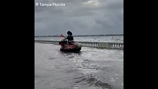 During Hurricane Idalia, individuals are seen paddleboarding, and biking