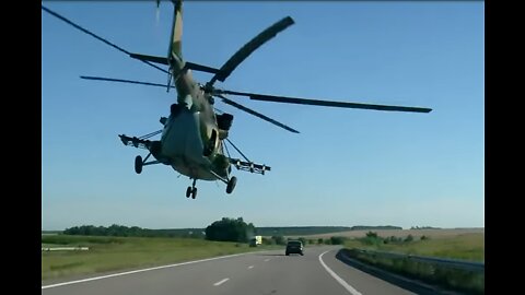 Helicopter Flying Between Cars