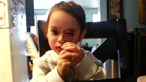 Girl gets caught using mommy's makeup, continues to apply it