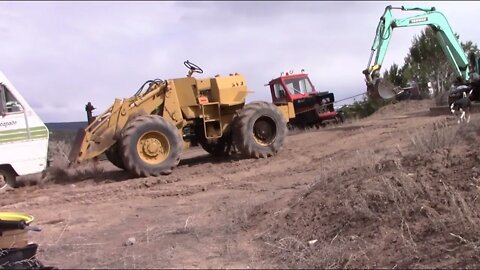 Yanmar Excavator Moving A 910 Cat Loader