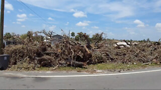 Debris still piled up along streets hit by tornado in northern Palm Beach County