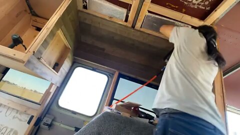 Putting up my reclaimed wood. On top of cedar of all things! In my #skoolie #skoolieconversion .