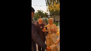 great-grandparents entering with rings at their grandson's wedding