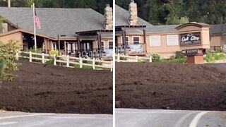 Massive mudslide flows over road like lava