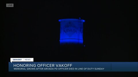 Arvada water tower lit in blue to honor fallen officer