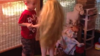 A Little Boy Dances and Kisses A Life Size Doll On A Trampoline