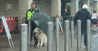 Officer Protects Dog From Rain