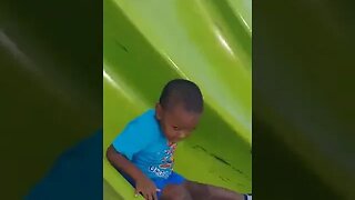 TJ sliding down the slide 24