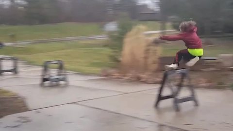 Young Boy Runs And Jumps Over A Sawhorse Like It's A Hurdle