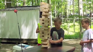 Boy takes giant Jenga blocks in the face