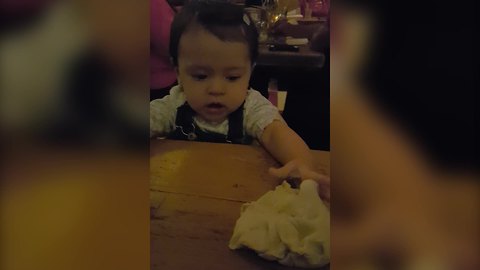A Cute Tot Plays with Dough in A Restaurant