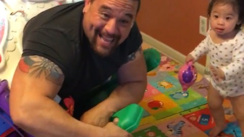 Muscular Dad Gets Stuck in Toddler's Toy