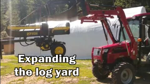 Using the Mahindra 2638 to expand the log yard.