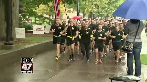UM and MSU ROTC members running game ball from East Lansing to Ann Arbor