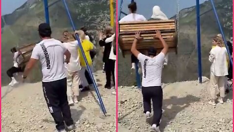 Terrifying moment two women fall off a swing on th