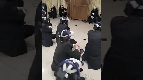 Hasidic men on a virtual reality tour of the temple