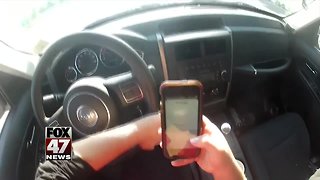 City bans handling phones while driving