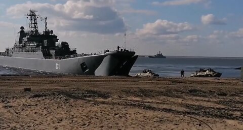 Landing of troops and military vehicles with Big Landing Ships on the beach.