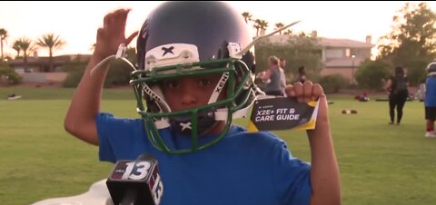 Raiders give away helmets at football camp