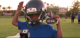 Raiders give away helmets at football camp