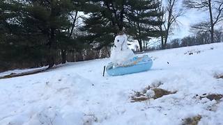 "A Snowman Sleds Down A Hill On A Tube"