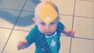 Baby petrified of cheese slice on forehead